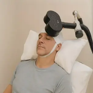Man receiving a clinical treatment on his head