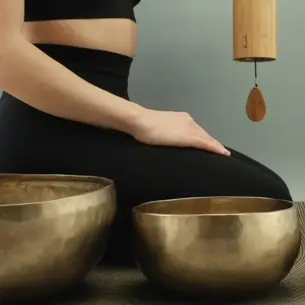 Person sitting next to a singing bowl